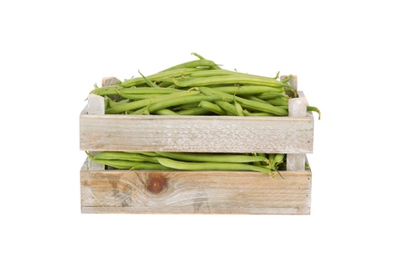Fresh green beans in a wooden crate isolated on a white backgroundの写真素材