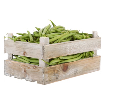 Fresh green beans in a wooden crate isolated on a white backgroundの写真素材
