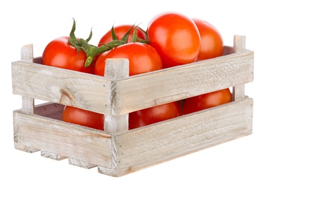 Fresh tomatoes in a wooden crate isolated on a white backgroundの写真素材
