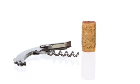 Cork and metal corkscrew on a reflective surface against whiteの写真素材