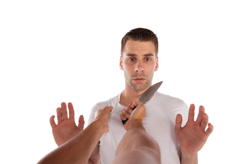 Man threatened with a knife isolated on white backgroundの写真素材
