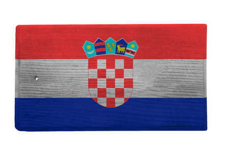 Old worn and scratched wooden cutting board with the Croatian flag on itの写真素材