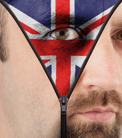 close-up of a face unzipping to show the flag of Englandの写真素材