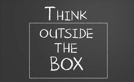 Think outside the box drawn on a chalkboard