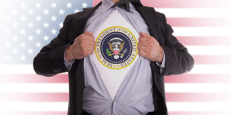 Businessman rips open his shirt to show his presidential seal t-shirtの写真素材