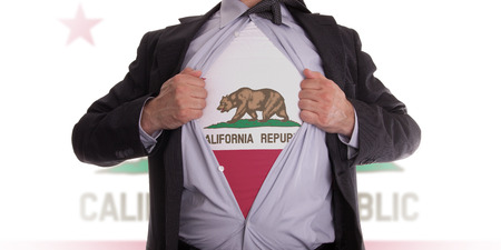 Businessman rips open his shirt to show his California flag t-shirtの写真素材