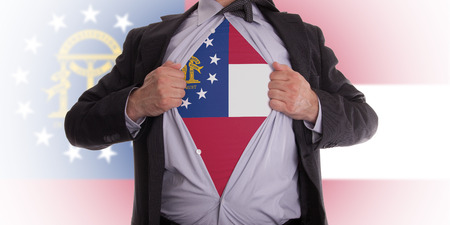 Businessman rips open his shirt to show his Georgia flag t-shirtの写真素材