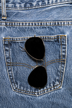 Sun glasses on a denim workers pocketの写真素材