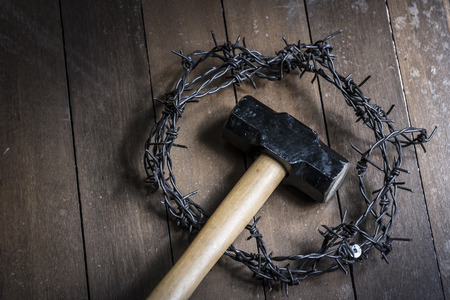 Hammer and crown of thorns on wooden floor. Easter religion concept.の写真素材