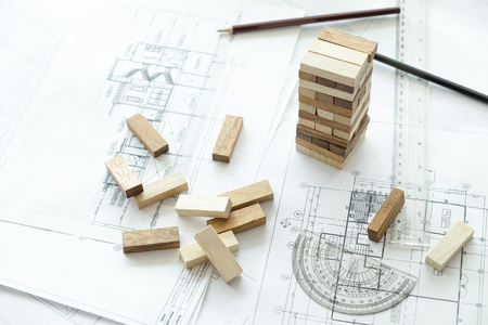 Planning, risk and strategy of project management in business, businessman and engineer gambling placing wooden block on a tower.Business and construction concept.の写真素材