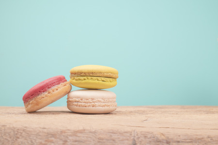 Macaroons on wooden table and retro vintage background colorの写真素材