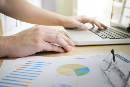 Businessman using computer to analyse business marketing data online. Business concept idea...