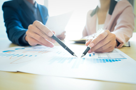 Young man and woman startups business teamwork meeting to discuss the situation on the marketing in the meeting room.の写真素材