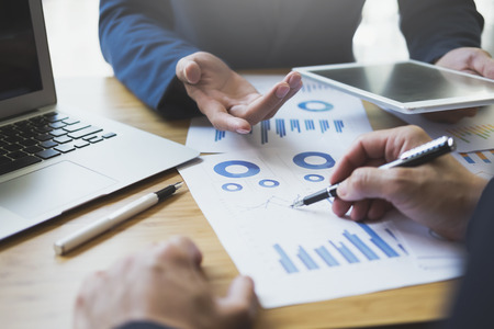 Businessman hand pointing at business document during discussion at meeting. Business analysis...
