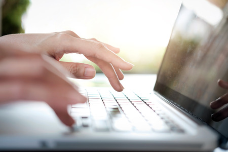 Business woman's hands typing on laptop keyboardの写真素材