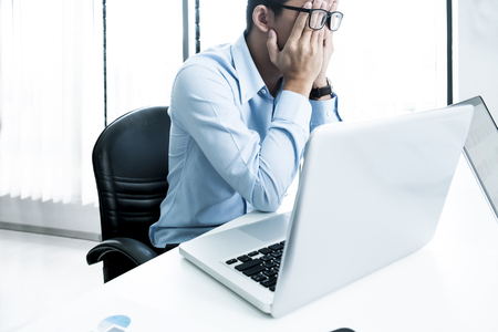 Serious businessman using laptop in office. Business analysis planing and solution objective strategy conceptの写真素材