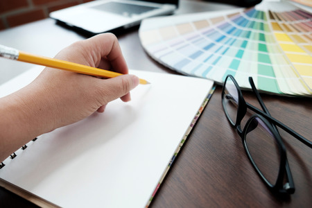Graphic design and color swatches and pens on a desk. Architectural drawing with work tools and accessories.の写真素材