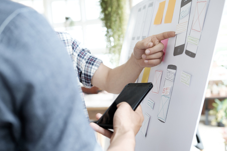Web designer, UX UI designer planning application for mobile phone.