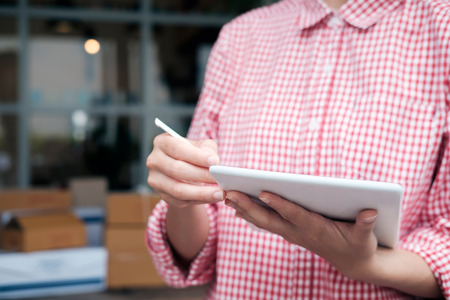 Young business start up online seller owner using computer for checking the customer orders from...