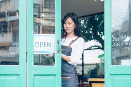 Open Small business: Happy owner of a cafe. Young startup owner small cafe shopの写真素材