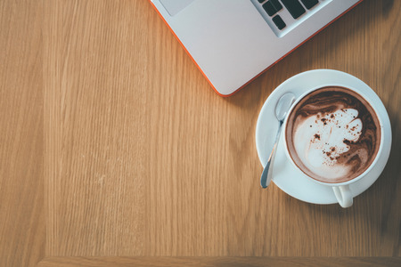 Morning working. Computer laptop newspaper and coffee.の写真素材