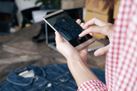 Online seller owner take a photo of product for upload to website online shop. Online Selling , Online Shopping and e-Commerce concept.の写真素材