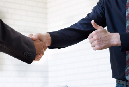 Businessmans handshake. Business partnership meeting concept. Successful businessmen handshaking after good dealの写真素材