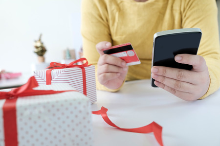 Woman holding credit card and doing shopping online. New year, Christmas gift shopping.の写真素材