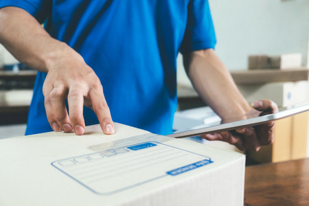 Courier checking the delivery receipt in office.