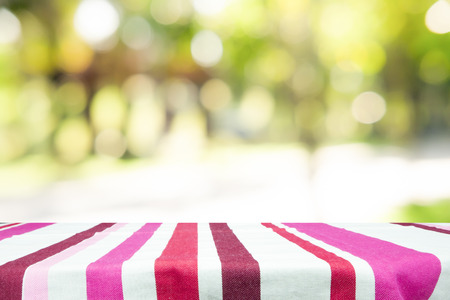 Empty table for present product with green bokeh out of focus background from nature forest
の写真素材