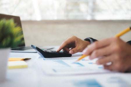 Finances Saving Economy concept. Businessman use calculator.の写真素材