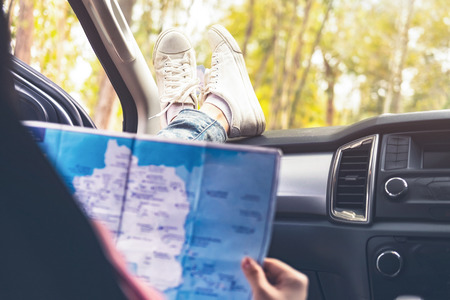 Young woman car traveler with map. の写真素材