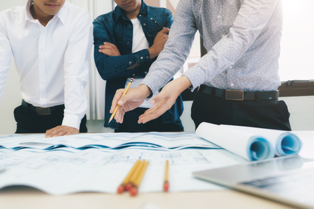 Image of engineer meeting for architectural project working with partner and engineering tools on workplace.の写真素材