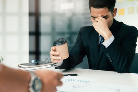 Stressed overwork business man in the office.の写真素材