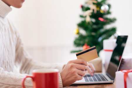 Man holding credit card and doing shopping online. New year, Christmas gift shopping.の写真素材