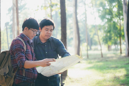 oung Man Traveler with backpack relaxing outdoor. Summer vacations and Lifestyle hiking concept. Retro filter effect, selective focus.の写真素材