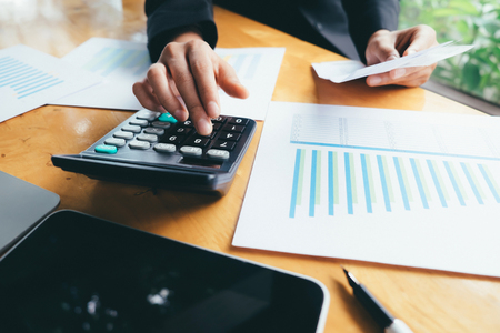 Finances Saving Economy concept. Accountant or banker calculate the cash bill.の写真素材