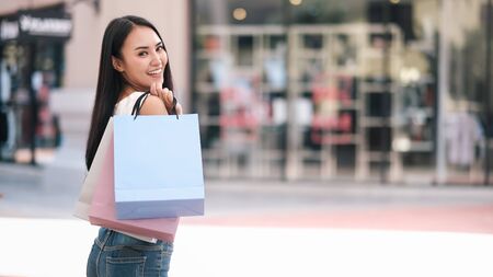 Happy beautiful asian woman with shopping bags enjoying in shopping. Lifestyle shopping and business concept.の写真素材