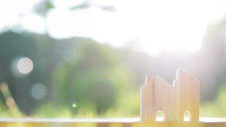 Close up diffirance wood house model on green blured background. Planning to buy property.の写真素材