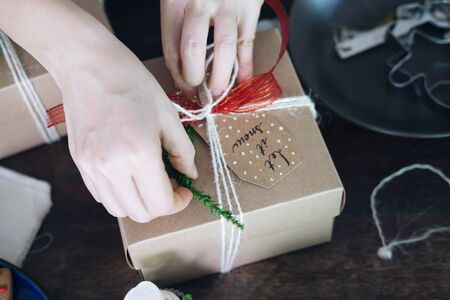 Preparing for Christmas and New Year holidays. Feale wrapping gift box.