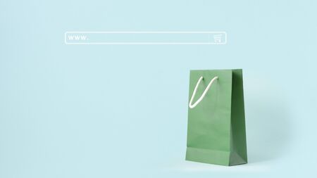 Background of shopping online concept. Search engine input box or web address bar. Green shopping bag on mint pastel color background.の写真素材