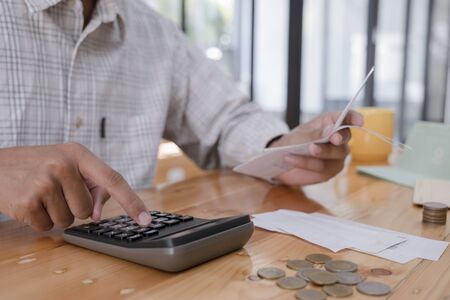 Finances Saving Economy concept. Accountant or banker calculate the cash bill.の写真素材