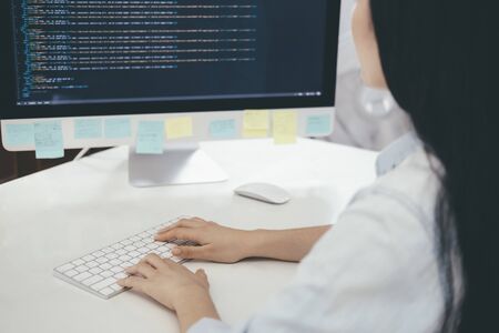 Programmer is coding and programming software. Software developer typing data code, working on project.の写真素材