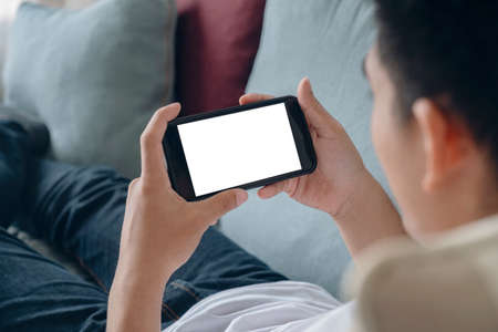 Close up of man hand holding smart phone. Blank screen mockup for graphics display montage.