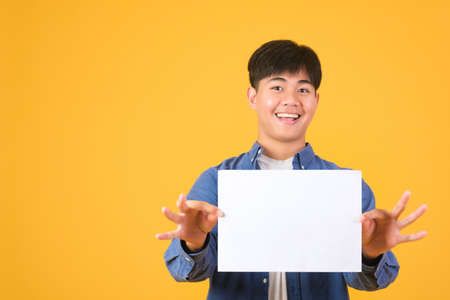 Male asian hand is holding blank paper board on white backgroundの写真素材