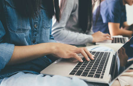 Closeup a group of young student using online connect technology for business or education and communication.の写真素材