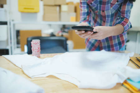 Online seller owner take a photo of product for upload to website online shop. Online Selling , Online Shopping and e-Commerce concept.の写真素材