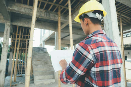 Asian man Engineer Stand and look at the work at the construction siteの写真素材