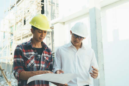 The engineering team working at building site meeting and discussing.の写真素材