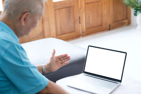 Happy senior man using online techology.